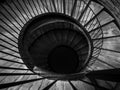 Spiral staircase. Black and white image of wooden and iron spiral stairway. Royalty Free Stock Photo