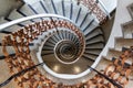Spiral staircase with brown metal railing. Perspective photography. Indoor architecture.