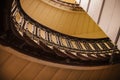 Spiral staircase curve with forged mwtallic fencing and selective focus, toned