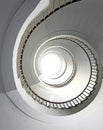 spiral staircase going up vertically without people and white light at the top