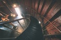 A spiral staircase inside a lighthouse. - vintage film effect