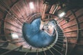 A spiral staircase inside a lighthouse. - vintage film effect