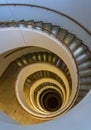 Spiral Staircase Leads Down Several Floors With Dramatic Lighting Royalty Free Stock Photo