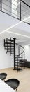 Spiral staircase in loft, vertical panorama