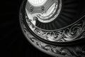 Spiral staircase from a low angle, highlighting the curves and architectural details