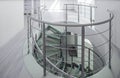 Spiral staircase made of glass and metal in luxury house. Royalty Free Stock Photo