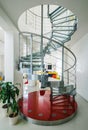 Spiral staircase made of metal and glass in luxury private house. Royalty Free Stock Photo