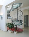 Spiral staircase made of metal and glass in luxury private house. Royalty Free Stock Photo