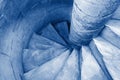 Spiral staircase with marble stairs toned in trendy classic blue - color of the year 2020 concept Royalty Free Stock Photo