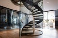 a spiral staircase with a mirrored railing, leading to the next level