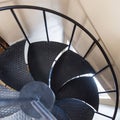 Spiral staircase in painted black cast iron. spiral embossed on rough metal cast, psychedelic brown gold metallic texture Royalty Free Stock Photo