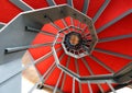 Spiral staircase with red carpet in a modern building Royalty Free Stock Photo