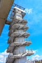 Spiral staircase to the bridge. spiral concrete staircase. a spiral concrete staircase against a blue sky. Royalty Free Stock Photo