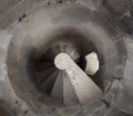 Spiral staircase vanishing downstairs. Stone steps and walls of tower. Stairs of old building Royalty Free Stock Photo