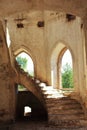 Spiral stone staircase and arch windows of the old ruined Lutheran church built in the Gothic style. Journey to the cantons of the Royalty Free Stock Photo