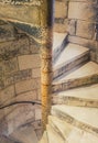 A spiral stone staircase in a narrow high tower