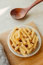 Spiral tortiglioni pasta in plate in bright kitchen. homemade pasta made from durum wheat. cooking Mediterranean dishes. food