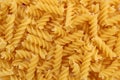 Texture of golden pasta in the form of a spiral for cooking