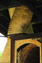 Spiral yellow brick chimney and arched fireplace