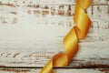 Spiral Yellow ribbon on wooden background Royalty Free Stock Photo