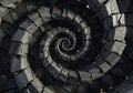 A spiraling pattern composed of irregular, dark stone blocks creates a striking optical Royalty Free Stock Photo
