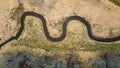 Spiraling river in spring next to woods