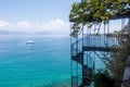 Spiraling staircase leading towards the vast ocean in Corfu, Greece