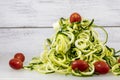 Spiralized Zucchini Noodles with Tomatoes on a Cutting Board