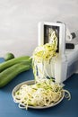 Spiralizing courgette raw vegetable with spiralizer Royalty Free Stock Photo