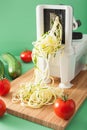 Spiralizing courgette raw vegetable with spiralizer Royalty Free Stock Photo
