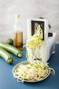 Spiralizing courgette raw vegetable with spiralizer Royalty Free Stock Photo