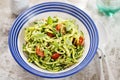 Spiralled courgette with green pesto and cherry tomatoes Royalty Free Stock Photo