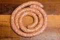 Spiralled spicy raw sausages