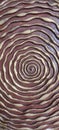 Spiralling golden ribbon on wood carving