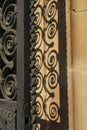 Spiraled wrought iron railing door with shadow