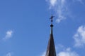 The spire of the Christian church with a cross on a background of blue sky Royalty Free Stock Photo