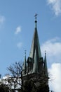 The spire of the Christian church with a cross on a background of blue sky Royalty Free Stock Photo