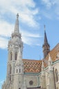 The spire of the famous Matthias Church in Budapest, Hungary. Roman Catholic church built in the Gothic style. Orange colored tile Royalty Free Stock Photo