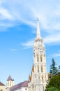 Spire of the Matthias Church in Budapest, Hungary on a vertical photo. Roman Catholic church built in the Gothic style. Blue sky Royalty Free Stock Photo