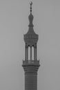 A spire and minaret of a islamic mosque in black and white. Religious concepts