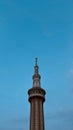 The spire of the mosque against the background of the blue sky Royalty Free Stock Photo