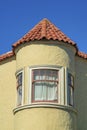 Spire or turrent on a house or building with red adobe roof tiles and beige stucco exterior with white accent paint Royalty Free Stock Photo