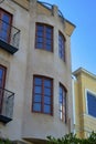 Spire or turret style bedroom building apartment complex or townhome house stucco beige exterior brown window frames Royalty Free Stock Photo