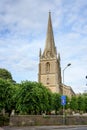 Spire of a typical English chruch against a cloudy blue sky Royalty Free Stock Photo