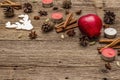 Spirit Christmas background. Apple, candles, spices, deer, cones. Nature New Year decorations, vintage wooden boards