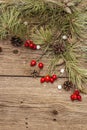 Spirit Christmas background. Fresh dog-rose berries, ball candies, pine branches and cones, artificial snow. Nature decorations, Royalty Free Stock Photo