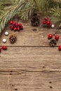 Spirit Christmas background. Fresh dog-rose berries, ball candies, pine branches and cones, artificial snow. Nature decorations, Royalty Free Stock Photo