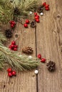 Spirit Christmas background. Fresh dog-rose berries, ball candies, pine branches and cones, artificial snow. Nature decorations, Royalty Free Stock Photo