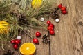 Spirit Christmas background. Fresh mandarins, dog-rose berries, candies, pine branches and cones, artificial snow Royalty Free Stock Photo