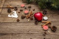 Spirit Christmas background. New Year tree, apple, candles, spices, deer, cones. Nature decorations, vintage wooden boards